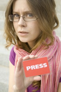 Mom blogger holding up her press badge